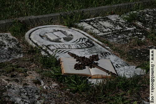 [Picture: Open book with iron cross on grave]