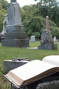 [Picture: Open Bible and cross in graveyard (portrait version)]
