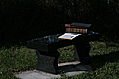 [Picture: Stone bench with books 1]