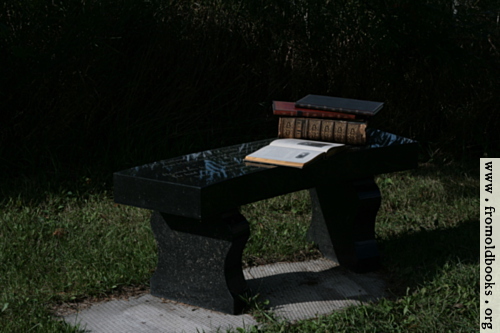 [Picture: Stone bench with books 1]