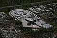 Open book with iron cross on grave