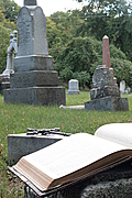 Open Bible and cross in graveyard (portrait version)